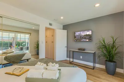 a bedroom with a bed and a couch and a table at F-54 Maverick in Anaheim