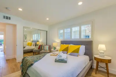 a bedroom with a large bed and a living room at F-54 Maverick in Anaheim