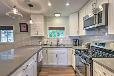 a kitchen with white cabinets and a stove top oven at F-55 Donald Ducks Cottage in Anaheim