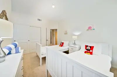 a white living room with two white couches at F-56 Winnie the Poohs Treehouse in Anaheim