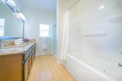 a bathroom with a tub and a sink and a bath tub at F-56 Winnie the Poohs Treehouse in Anaheim