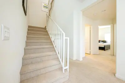 a staircase in a home with white walls at F-56 Winnie the Poohs Treehouse in Anaheim