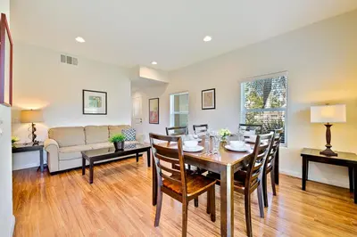a dining room and living room with a table and chairs at F-56 Winnie the Poohs Treehouse in Anaheim