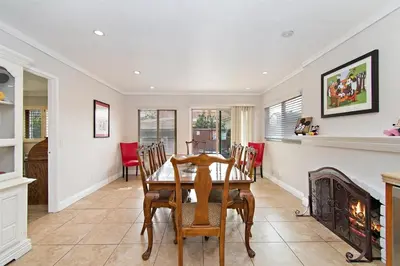 a dining room with a table and a fireplace at F-57 Pride Rock in Anaheim