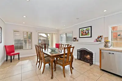 a dining room with a table and a fireplace at F-57 Pride Rock in Anaheim