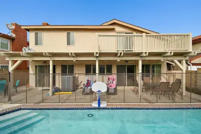 a house with a swimming pool in front of a house at F-57 Pride Rock in Anaheim