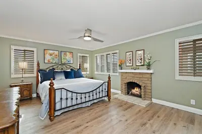 a bedroom with a bed and a fireplace at F-57 Pride Rock in Anaheim