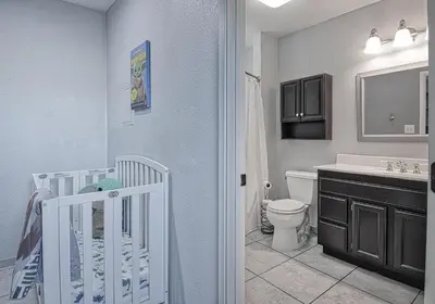 a bathroom with a crib and a toilet and a sink at F-58 Mandos Hideaway in Anaheim