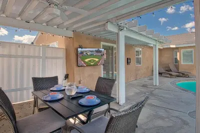 a patio with a table and chairs and a television at F-58 Mandos Hideaway in Anaheim
