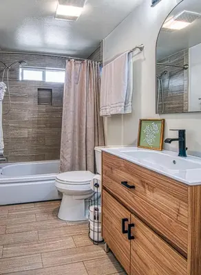 a bathroom with a toilet and a tub and a sink at F-59 Goodhue in Anaheim
