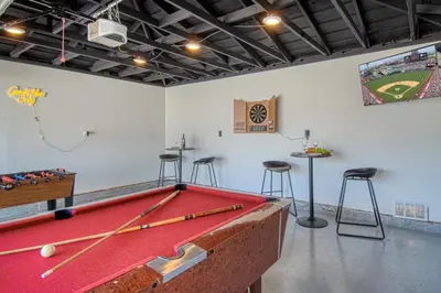 a room with a pool table and bar stools at F-59 Goodhue in Anaheim