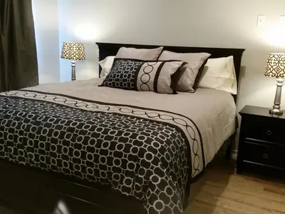 a bedroom with a large bed with two lamps at F-60 Disney Dream Craftsman in Anaheim