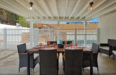 a wooden table and chairs on a patio at F-64 California Vibes in Anaheim