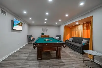 a living room with a pool table and a couch at F-65 Adventure House in Anaheim