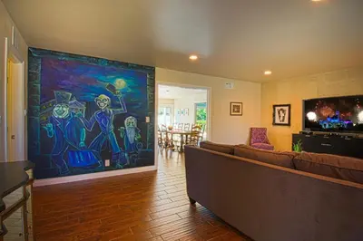 a living room with a large painting on the wall at F-15 Haunted Mansion in Anaheim