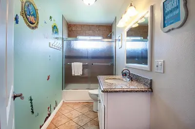 a bathroom with a shower and a sink and a toilet at F-18 Babes in Toyland in Anaheim