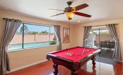 a room with a pool table and a ceiling fan at F-18 Babes in Toyland in Anaheim