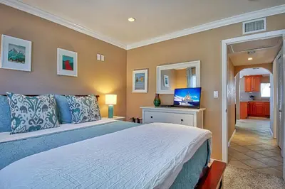 a bedroom with a large bed and a television at F-20 Paradise Pier in Anaheim