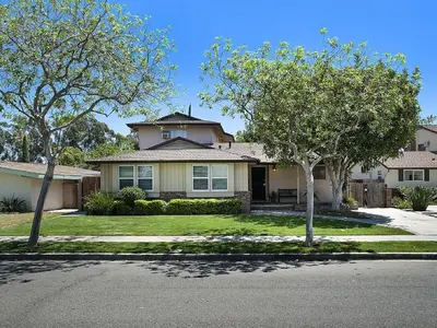 a house with two trees in front of it at F-21 Castle House 1 in Anaheim