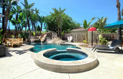 a swimming pool with a fountain in a backyard at F-22 Castle House 2 in Anaheim