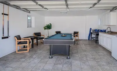 a room with a pool table in a kitchen with chairs at F-22 Castle House 2 in Anaheim