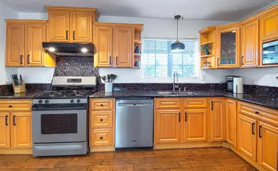 a kitchen with wooden cabinets and a stove top oven at F-22 Castle House 2 in Anaheim