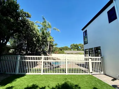 a white picket fence in front of a house at F-23 Rapunzels Tower in Anaheim