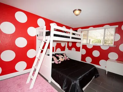 a bedroom with a red and white polka dot wall at F-24 Mickeys House in Anaheim