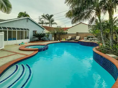 a large swimming pool with blue water in a yard at F-34 Minnies House in Anaheim