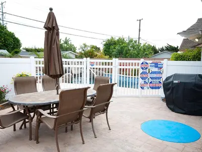a patio with a table and chairs and an umbrella at F-30 Small World in Anaheim