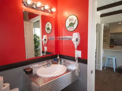a bathroom with a sink and a red wall at F-26 Andys House in Anaheim