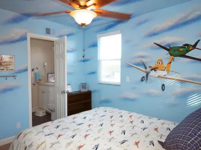 a bedroom with a blue ceiling with planes on the wall at F-26 Andys House in Anaheim