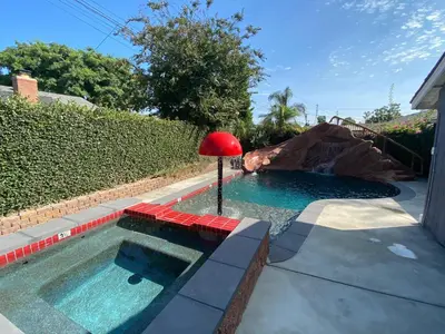a small pool with a red lamp in a backyard at F-26 Andys House in Anaheim