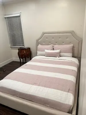 a bedroom with a large bed with pink and white stripes at Beautiful 2-bedroom downstairs unit by LAX, SoFi, BMO, USC in Los Angeles