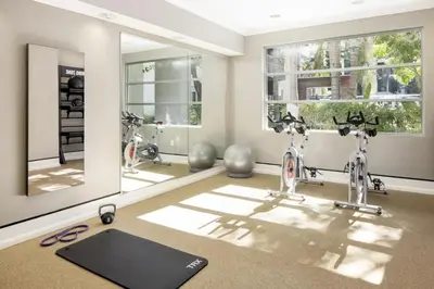 a gym with two bikes in a room with mirrors at Prime Santa Monica 1 bed & bath in Los Angeles