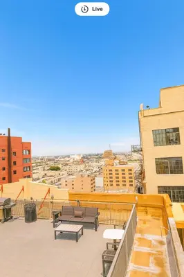 a balcony with benches and tables on a building at Loft in Downtown Los Angeles in Los Angeles