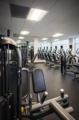 a gym with rows of treadmills and machines at Loft in Downtown Los Angeles in Los Angeles