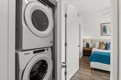 a washer and dryer in a room with a bed at Luxury Penthouse 2-BR - with Pool & Gym Access in Los Angeles