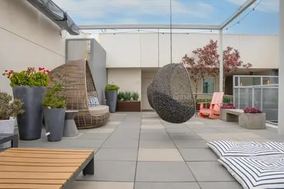 two images of a patio with benches and plants at Luxury Penthouse 2-BR - with Pool & Gym Access in Los Angeles