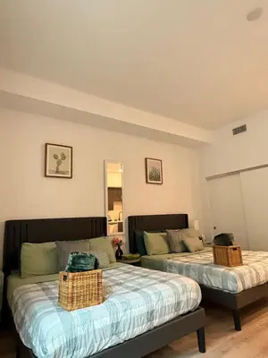 a room with two beds and a couch at Vine Loft FREE DESIGNATED PARKING & WIFI close to Universal Studios in Los Angeles