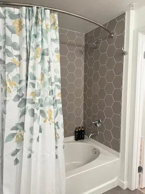 a bathroom with a tub and a shower curtain at Vine Loft FREE DESIGNATED PARKING & WIFI close to Universal Studios in Los Angeles