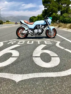 a motorcycle parked on the side of a road at Cozy Container in Devore Heights, California, for Glamping Getaways on Route 66 in Devore Heights