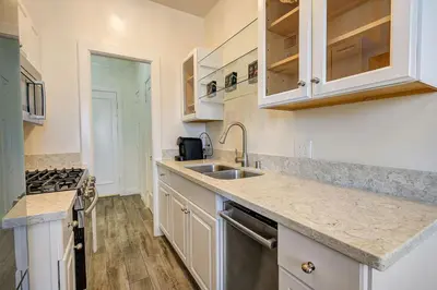 a kitchen with white cabinets and a sink at Long Beach Panorama in Long Beach