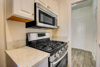 a kitchen with a stove and a microwave at Long Beach Panorama in Long Beach