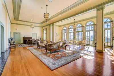 an open living room with wood floors and windows at Long Beach Panorama in Long Beach