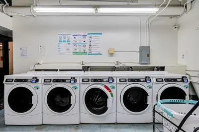 a laundry room with three washing machines in it at Long Beach Panorama in Long Beach