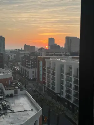 a view of a city at sunset from a building at Long Beach Panorama in Long Beach