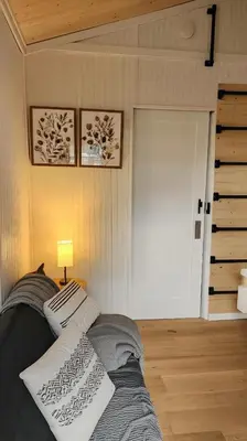 a bedroom with a bed with two pillows on it at Tiny House Living with In Unit Laundry Steps from Kaiser in Litton Industries Heliport