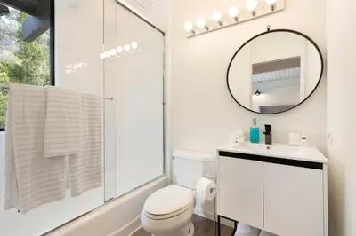 a bathroom with a toilet and a sink and a mirror at Malibu Reserve by Stay Awhile Villas in Malibu