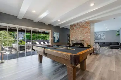 a pool table in a room with a fireplace at Mulholland Drive with Spa & Game Room in Los Angeles